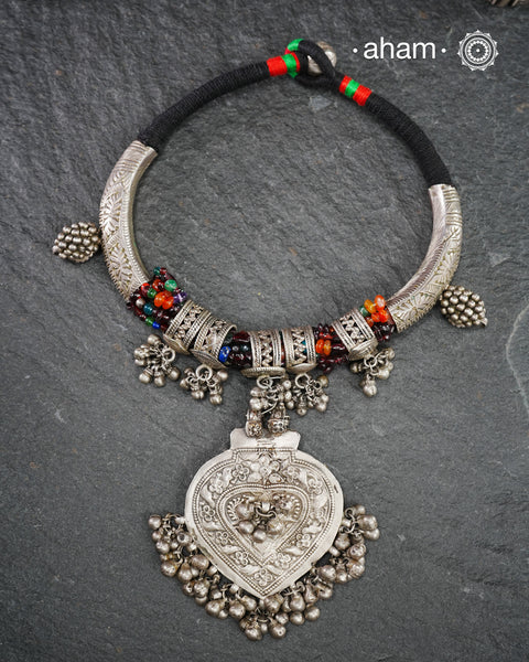 One of a kind made up Tribal Silver Neckpiece features a stunning pendant as the central piece, beautiful hasli parts on the side and strung together with multi coloured beads and Silver rings for added drama. A true treasure for any jewellery lover.