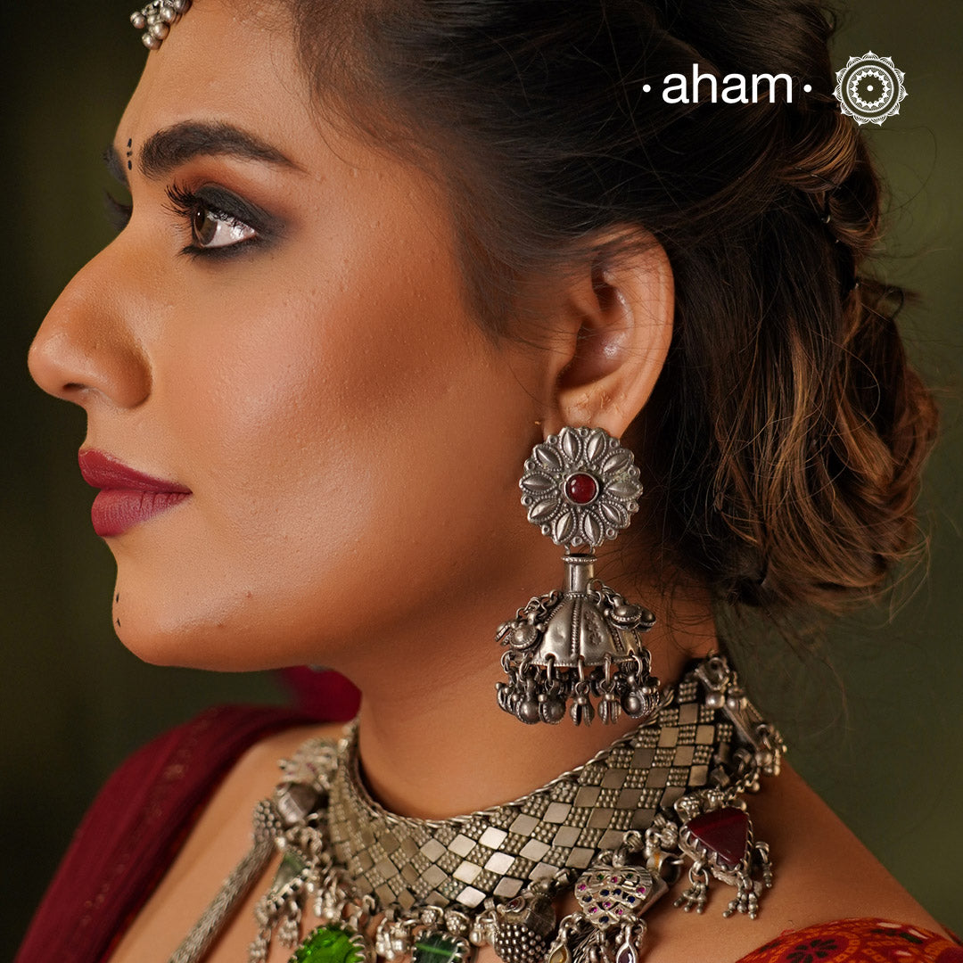 Statement Tribal Silver Jhumkie Earrings - These bold, handcrafted silver jhumkie earrings feature intricate tribal designs with a pop of red colour that embody authentic vintage charm. The delicate ghungroos create a delightful sound with every movement, adding a playful yet traditional touch. Perfect for those who appreciate heritage jewellery with a modern twist, these earrings are an eye-catching addition to any collection.