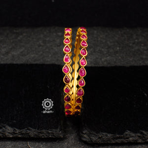 Handcrafted 92.5 sterling silver bangles with gold polish and rani pink kundan work. Perfect pair for special occasions and gifting.