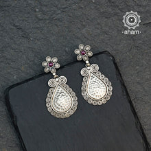 Beautiful Mewad drop earrings with a maroon stone flower stud. Handcrafted in 92.5 sterling silver, an ode to the glorious state of Rajasthan.