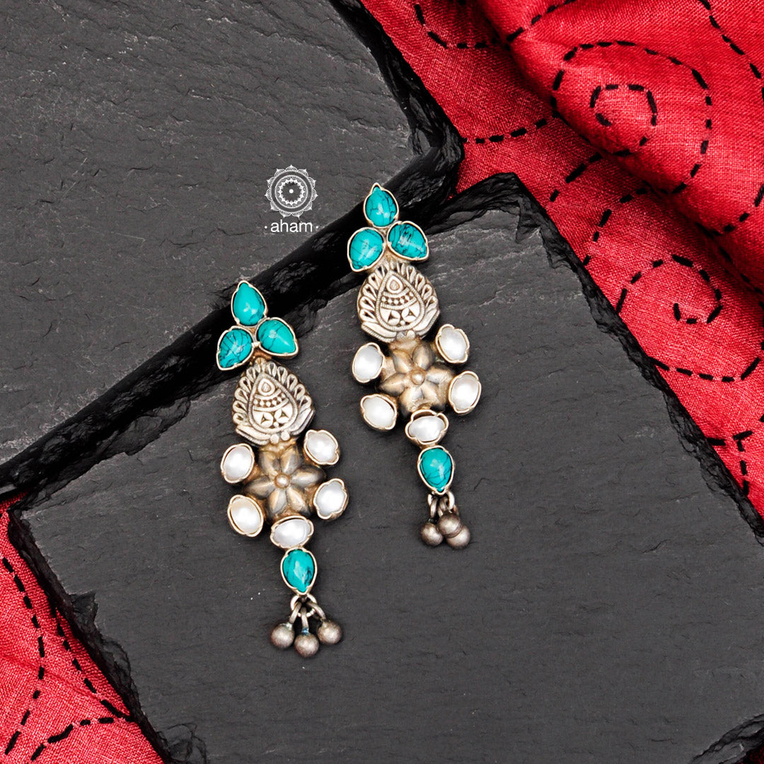 Perfect summer wear earrings crafted in 92.5 silver with turquoise and pearl highlights. 