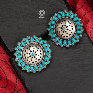 Beautiful silver studs with cut work center and turquoise coloured stone highlights. Crafted in 92.5 silver, these are great statement makers. 