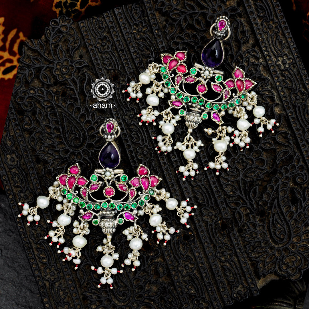 Handcrafted floral motifs with semi precious stones and cultured pearl detail these chandelier 92.5 sterling silver earrings will add more bling and drama to your jewellery collection. Style this up with your favorite silk saree or even your lehengas 