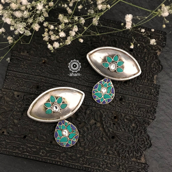 Handcrafted in 92.5 sterling silver with floral motifs and semi precious stones. These Festive lotus earrings will add more bling and drama to your jewellery collection.  