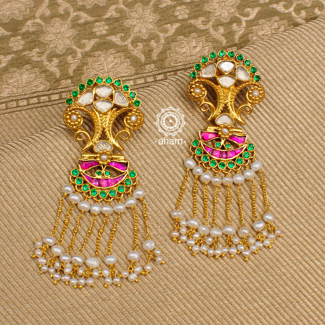 Beautiful gold polish earrings with semi precious stone setting. Handcrafted in 92.5 sterling silver with kundan work and dangling cultured pearls.