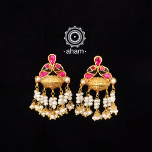 Beautiful gold polish earrings with bird motif in rani pink setting. Handcrafted using traditional methods in 92.5 sterling silver with dangling cultured pearls. Beautiful gold polish earrings with bird motif in rani pink setting. Handcrafted using traditional methods in 92.5 sterling silver with dangling cultured pearls. Lightweight danglers, perfect for intimate weddings and upcoming festive celebrations. 