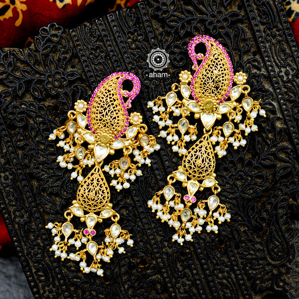 Feel like royalty when dressed in these Paisley Gold Polish Silver Earrings. Crafted using traditional techniques in 92.5 sterling silver with gold polish, semi precious stones and cultured pearls. A perfect wear with your traditional sarees and lehengas for intimate weddings and upcoming festive celebrations.