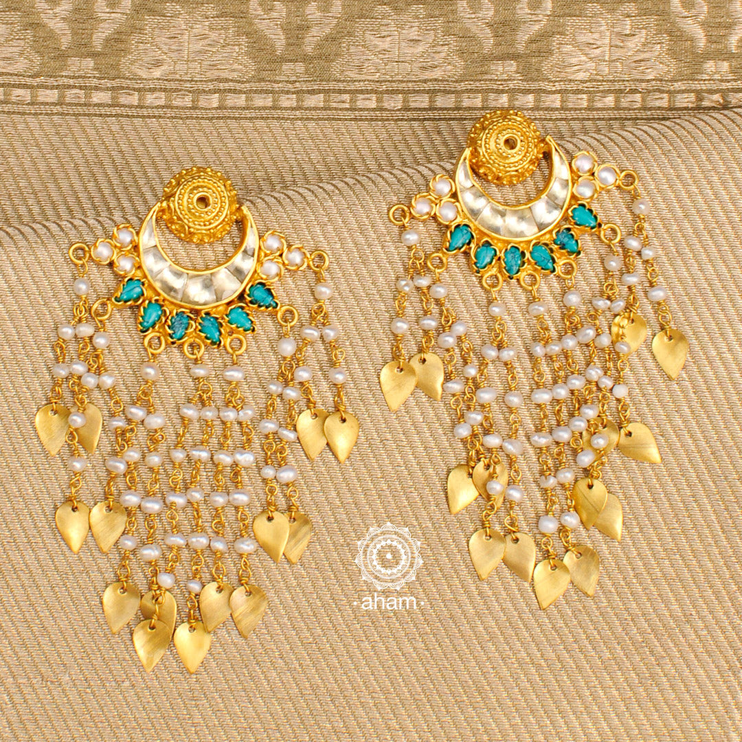 Handcrafted gold polish kundan crescent earrings. Crafted using traditional techniques in 92.5 sterling silver with dangling cultured pearls and turquoise coloured drops. Perfect for special occasions and upcoming festive celebrations.