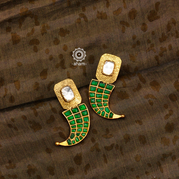 Handcrafted tiger claw silver earrings. Created in 92.5 sterling silver with gold polish and green semi precious stone setting. Designed keeping modern sensibilities in mind, perfect for special occasions and festivities. 