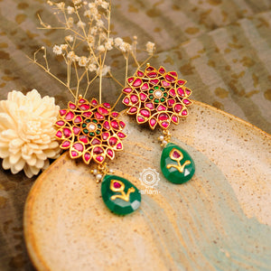 Handcrafted silver gold polish earrings with green drop dangling on a rani pink setting flower stud. Pair these elegant earrings with your favourite ethnic or fusion outfit this festive season.