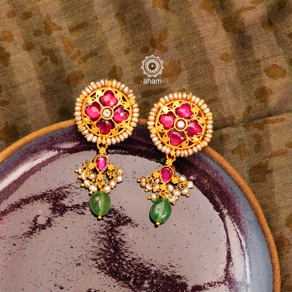 Elegant gold polish flower earrings with embellished cultured pearls. Handcrafted in 92.5 sterling silver with rani pink stone setting. Lightweight earrings perfect for special occasions and festivities.