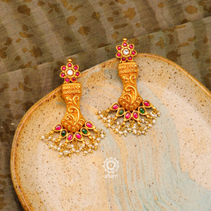 Feel like royalty when dressed in these gold polish silver earrings with dangling cultured pearls. Handcrafted using traditional techniques with intricate floral work and kundan work. Perfect for intimate weddings and upcoming festive celebrations. 