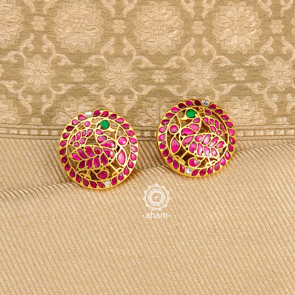 Feel like royalty when dressed in these gold polish peacock studs. Beautiful earrings handcrafted in 92.5 sterling silver with rani pink coloured semi precious stones. This pair is perfect for special occasions and festivities 