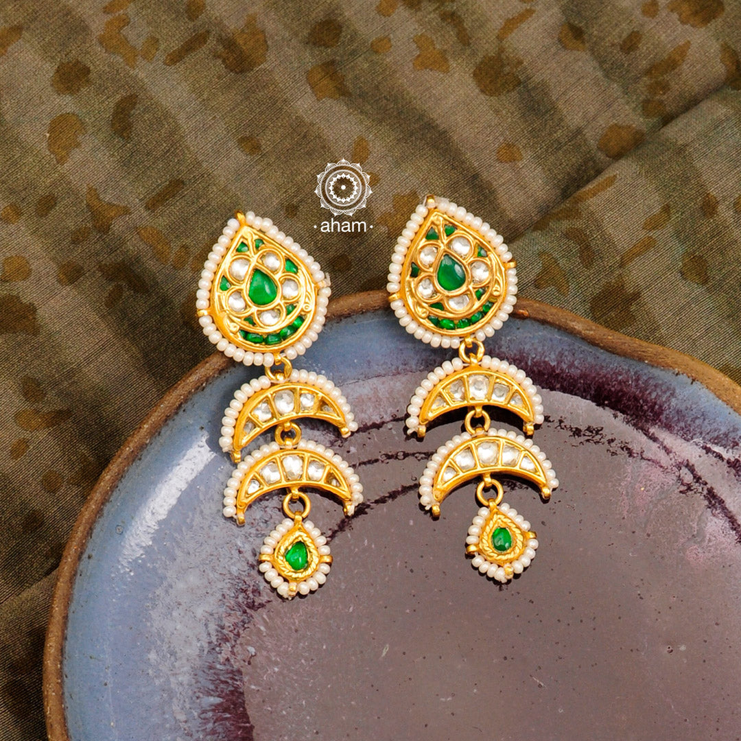 Handcrafted green and kundan drop 92.5 sterling silver earrings with gold polish. Lightweight earrings perfect for special occasions and festivities.