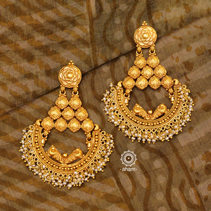 Statement gold polish chandbali earring with intricate floral work. Handcrafted using traditional methods in 92.5 sterling silver with  dangling cultured pearls. Pair these with your ethnic outfits this festive season to ace your look.