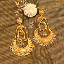 Statement gold polish chandbali earring with intricate floral work. Handcrafted using traditional methods in 92.5 sterling silver with  dangling cultured pearls. Pair these with your ethnic outfits this festive season to ace your look.