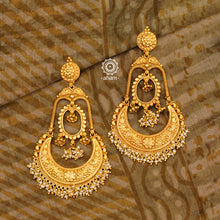 Statement gold polish chandbali earring with intricate floral work. Handcrafted using traditional methods in 92.5 sterling silver with  dangling cultured pearls. Pair these with your ethnic outfits this festive season to ace your look.