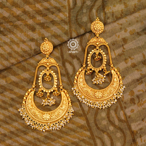 Statement gold polish chandbali earring with intricate floral work. Handcrafted using traditional methods in 92.5 sterling silver with  dangling cultured pearls. Pair these with your ethnic outfits this festive season to ace your look.