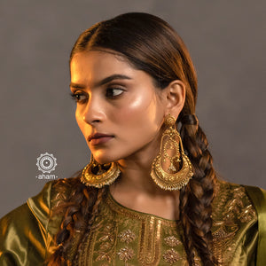 Statement gold polish chandbali earring with intricate floral work. Handcrafted using traditional methods in 92.5 sterling silver with dangling cultured pearls. Pair these with your ethnic outfits this festive season to ace your look.