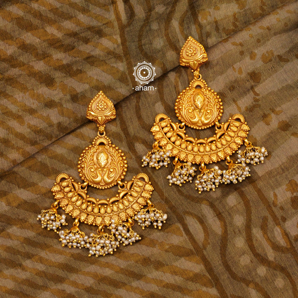 Statement gold polish chandbali earring with multiple mini dangling jhumkies. Handcrafted using traditional methods in 92.5 sterling silver with cultured pearls. Pair these with your ethnic outfits this festive season to ace your look.