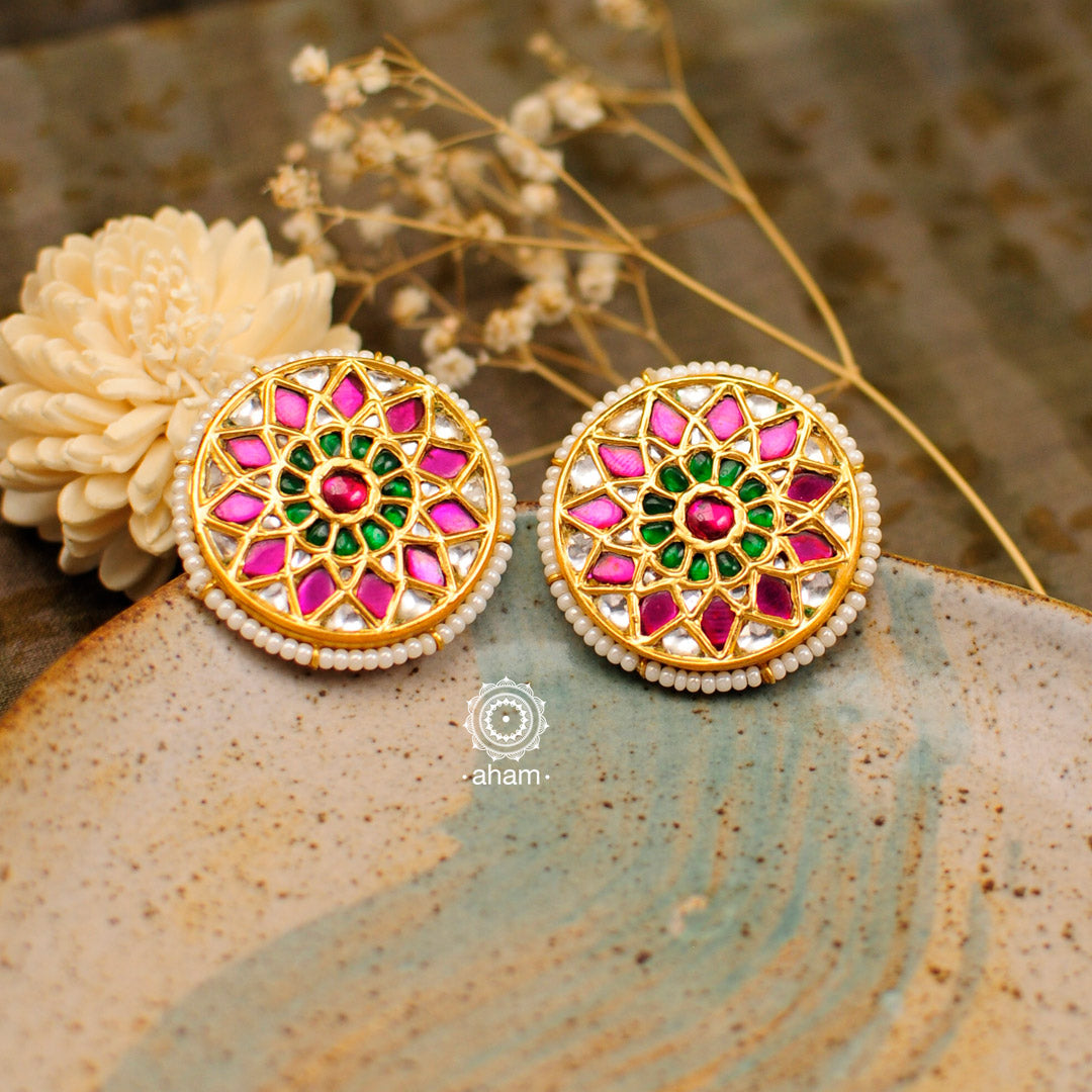 Festive gold polish studs with vibrant floral work. Handcrafted in 92.5 sterling silver using jadau kundan techniques. Perfect for special occasions, pair these floral earrings with your favorite ethnic outfits.