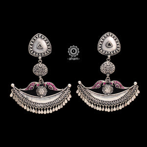 Shivneri chandbali statement earrings. Handcrafted in 92.5 sterling silver with rani pink peacock motifs resting on a beautiful crescent. Perfect for special occasions and gifting.