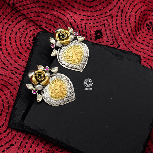 Noori two tone earrings with a blooming rose motif stud. Handcrafted in 92.5 sterling silver with intricate floral work. Style this up with your favourite ethnic or fusion outfits to complete the look.