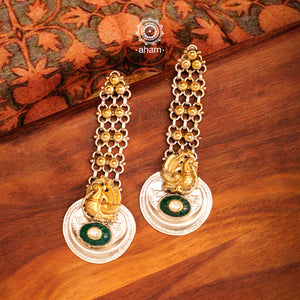 Long Noori two tone earrings with green semi precious stone. Handcrafted in 92.5 sterling silver with intricate peacock motif. Style this up with your favourite ethnic or fusion outfit.