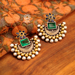 Noori two tone crescent earrings with semi precious green stone. Handcrafted in 92.5 sterling silver with blue spinel flower motif. Subtle elegance that add charm to your look. 