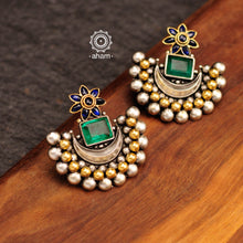 Noori two tone crescent earrings with semi precious green stone. Handcrafted in 92.5 sterling silver with blue spinel flower motif. Subtle elegance that add charm to your look. 