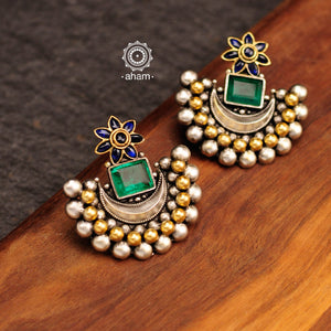 Noori two tone crescent earrings with semi precious green stone. Handcrafted in 92.5 sterling silver with blue spinel flower motif. Subtle elegance that add charm to your look. 
