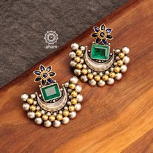 Noori two tone crescent earrings with semi precious green stone. Handcrafted in 92.5 sterling silver with blue spinel flower motif. Subtle elegance that add charm to your look. 