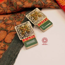 Noori two tone silver green stone earrings. Handcrafted in 92.5 sterling silver with red kundan setting. Style this elegant earrings with your favourite ethnic or fusion outfits to complete the look.