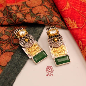 Noori two tone earrings with green semi precious stone setting. Handcrafted in 92.5 sterling silver. Style this up with your favourite ethnic or fusion outfits to complete the look. 