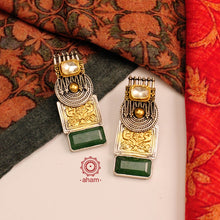 Noori two tone earrings with green semi precious stone setting. Handcrafted in 92.5 sterling silver. Style this up with your favourite ethnic or fusion outfits to complete the look. 