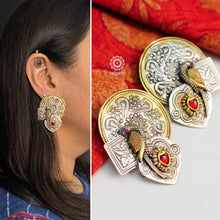 Handcrafted pieces of art put together to create this noori two tone parrot earrings in 92.5 sterling silver. Beautiful chidiya (bird) motif with green and maroon Kemp stone setting, gold polish work and cultured pearls. Style this up with your favourite ethnic or fusion outfit