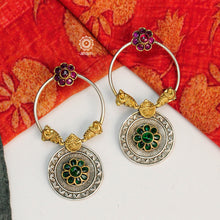 Noori dual tone earrings with delicate peacock motifs and beautiful maroon and green flowers. Handcrafted in 92.5 sterling silver. Style this up with your favourite ethnic or fusion outfit.