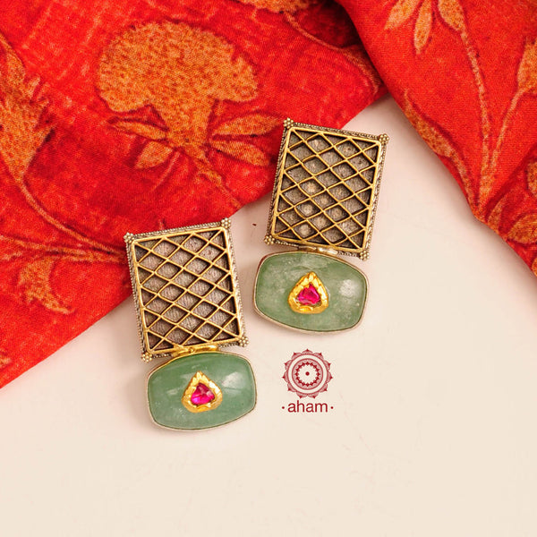 Noori two tone earrings with green semi precious stone setting. Handcrafted in 92.5 sterling silver. Style this up with your favourite ethnic or fusion outfits to complete the look.