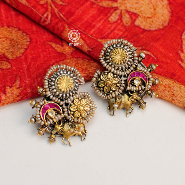 Noori two tone earrings with intricate floral work. Handcrafted in 92.5 sterling silver with Kamadhenu motif and embellished cultured pearls. Style this up with your favourite ethnic or fusion outfit.