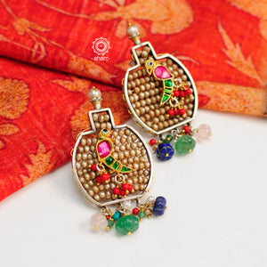 Handcrafted noori two tone earrings in 92.5 sterling silver. Beautiful parrot motif with kundan work and embellished cultured pearls. Style this up with your favourite ethnic or fusion outfit.