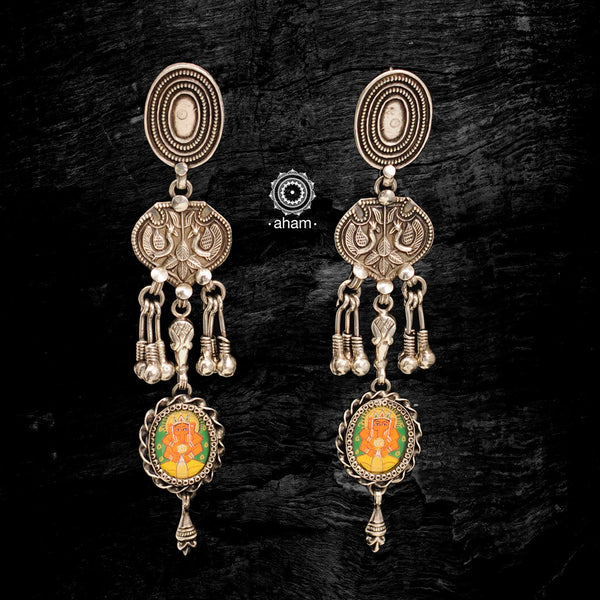 Light weight earrings with intricate miniature hand painted lord Ganesha motif in vibrant colours, enclosed with a glass top. Handcrafted in 92.5 sterling silver. 