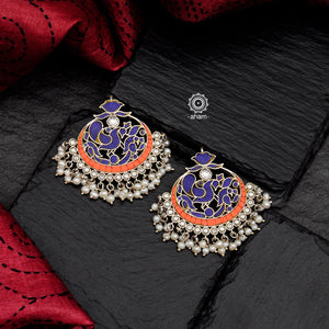 Handcrafted 92.5 sterling silver Ira chandbali earrings with elegant peacock motif in a semi precious stone setting with dangling cultured pearls. Can be paired with both ethnic and western outfits. 