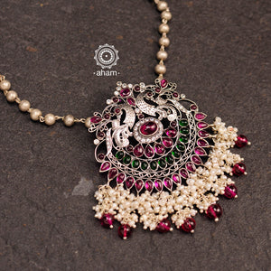 Dazzle up your look in this Nrityam double peacock neckpiece with green & maroon kemp stone setting. Handcrafted with love in 92.5 sterling silver with long silver ball chain and dangling cultured pearls. Looks fabulous with both ethnic and western outfits 