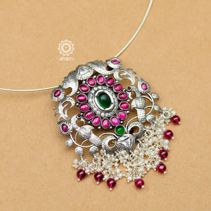 Flaunt this beautiful Nrityam hasli with elegant peacock motif pendant with dangling cultured pearls. Beautiful, handcrafted 92.5 sterling silver neckpiece with double peacock motif and intricate floral motif with green and maroon kemp stone setting. The pendant is removable you can also pair different pendants with this hasli.  
