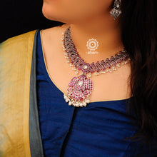 Bringing alive traditional forms in new avatars. This Gandaberunda neckpiece is crafted in 92.5 sterling silver using traditional techniques and studded with maroon Kemp stone settings and cultured pearls. Perfect for intimate weddings and upcoming festive celebrations. 
