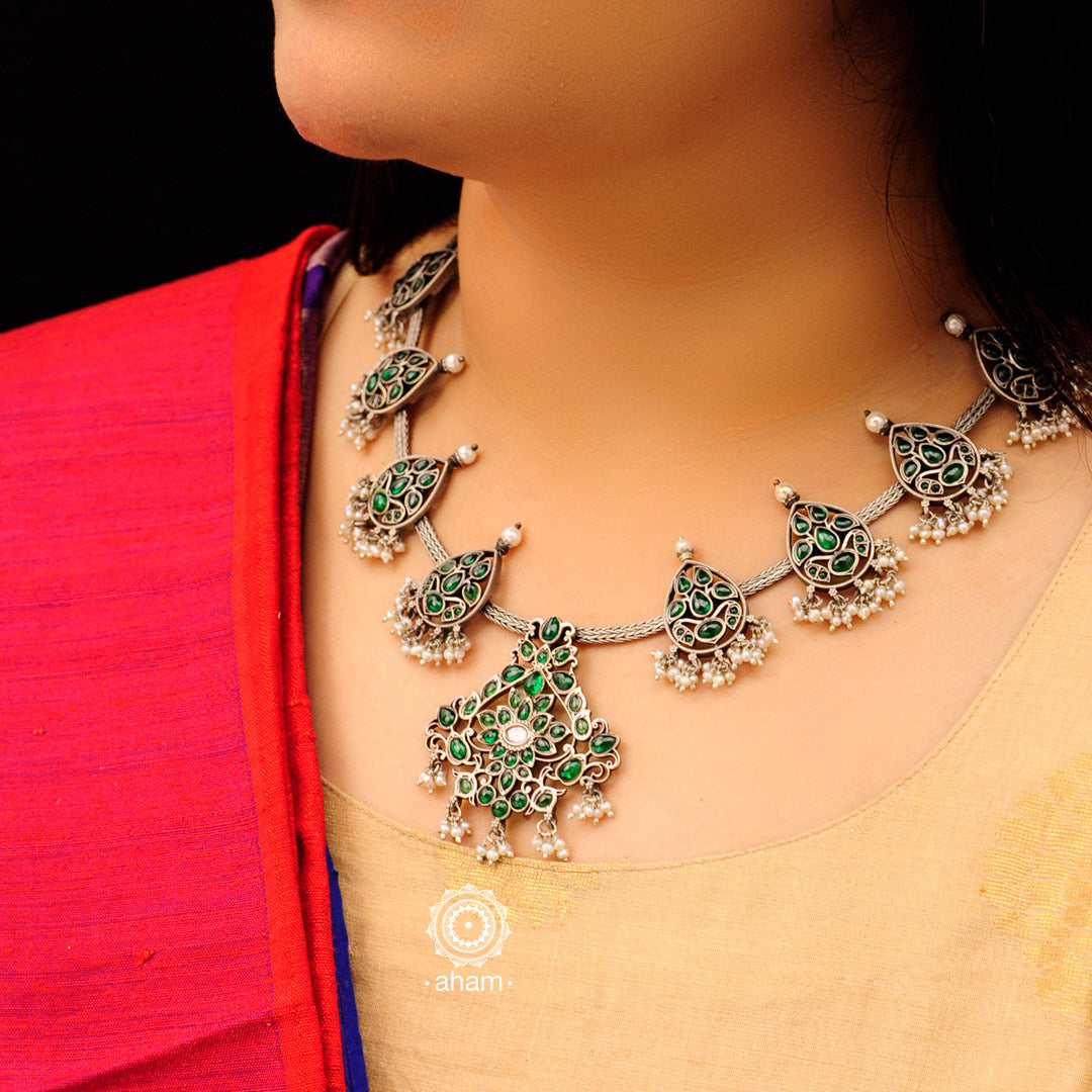 Make a sophisticated style statement this festive season in this Nrityam neckpiece. Handcrafted in 92.5 sterling silver using traditional artistry with green spinel stone setting. Perfect for intimate weddings and upcoming festive celebrations. 