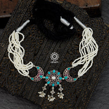 Nrityam choker handcrafted in 92.5 sterling silver, enhanced with maroon & turquoise coloured stone setting and pearls creating a dainty and elegant look. 