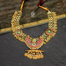 Make a sophisticated style statement with this handcrafted tribal anklet converted into an elegant amulet neckpiece. Crafted using traditional techniques in silver with gold polish, dangling cultured pearls, kundan work crescent & floral motifs. Perfect for intimate weddings and upcoming festive celebrations.