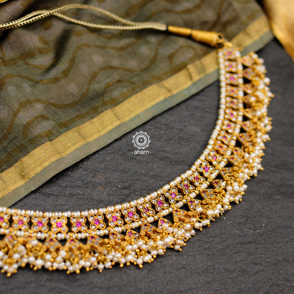 Make a sophisticated style statement with this gold polish festive neckpiece. Crafted using traditional techniques in silver with kundan floral motifs and cultured pearls. Perfect for intimate weddings and upcoming festive celebrations.