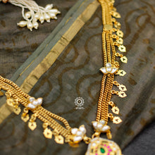 Make a sophisticated style statement with this elegant silver neckpiece. Necklace crafted using traditional techniques with dainty gold polish chain including kundan work floral motifs, tribal amulet and green semi precious stone drop. Perfect for intimate weddings and upcoming festive celebrations.